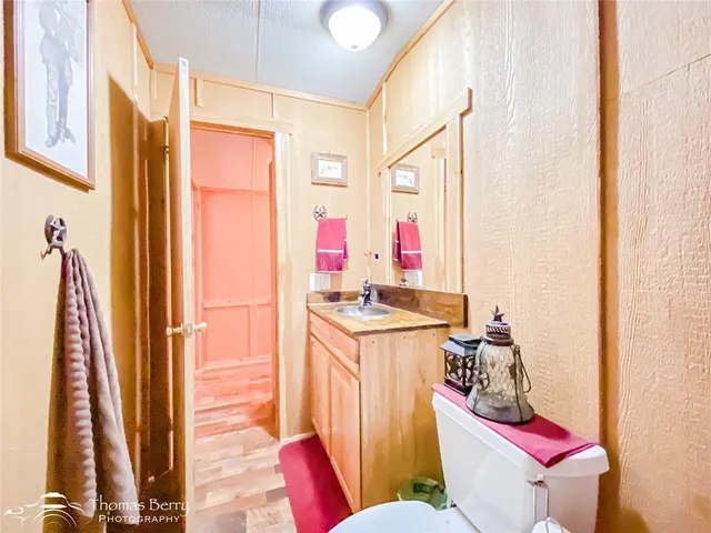 a bathroom with a granite countertop tub sink toilet a mirror and shower