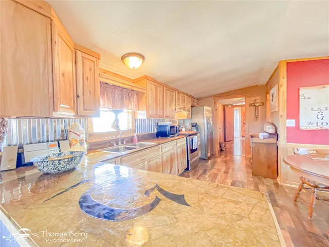 a kitchen with stainless steel appliances a stove a sink and a refrigerator