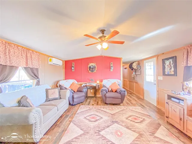 a bedroom with furniture and wooden floor