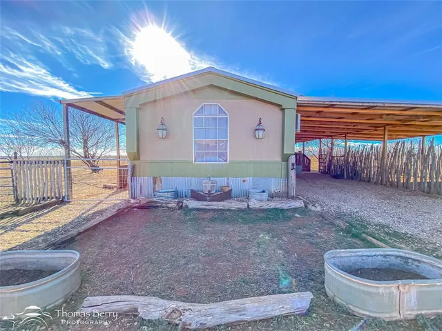 a view of backyard with wooden fence