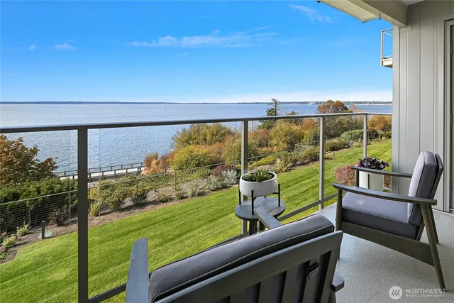 a view of a chairs and table in a balcony