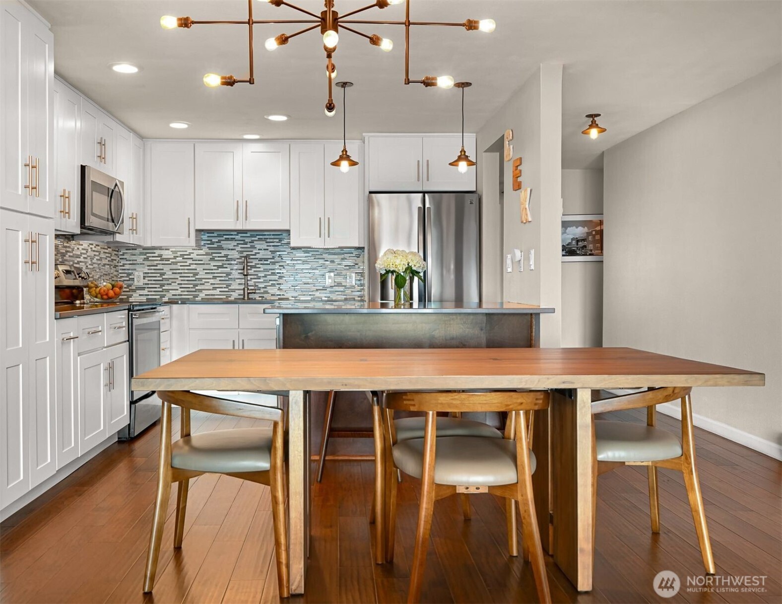 600 South State Street, Unit 212 Bellingham, WA 98225 - Photo 14 of 37 a kitchen with a table chairs refrigerator and stove