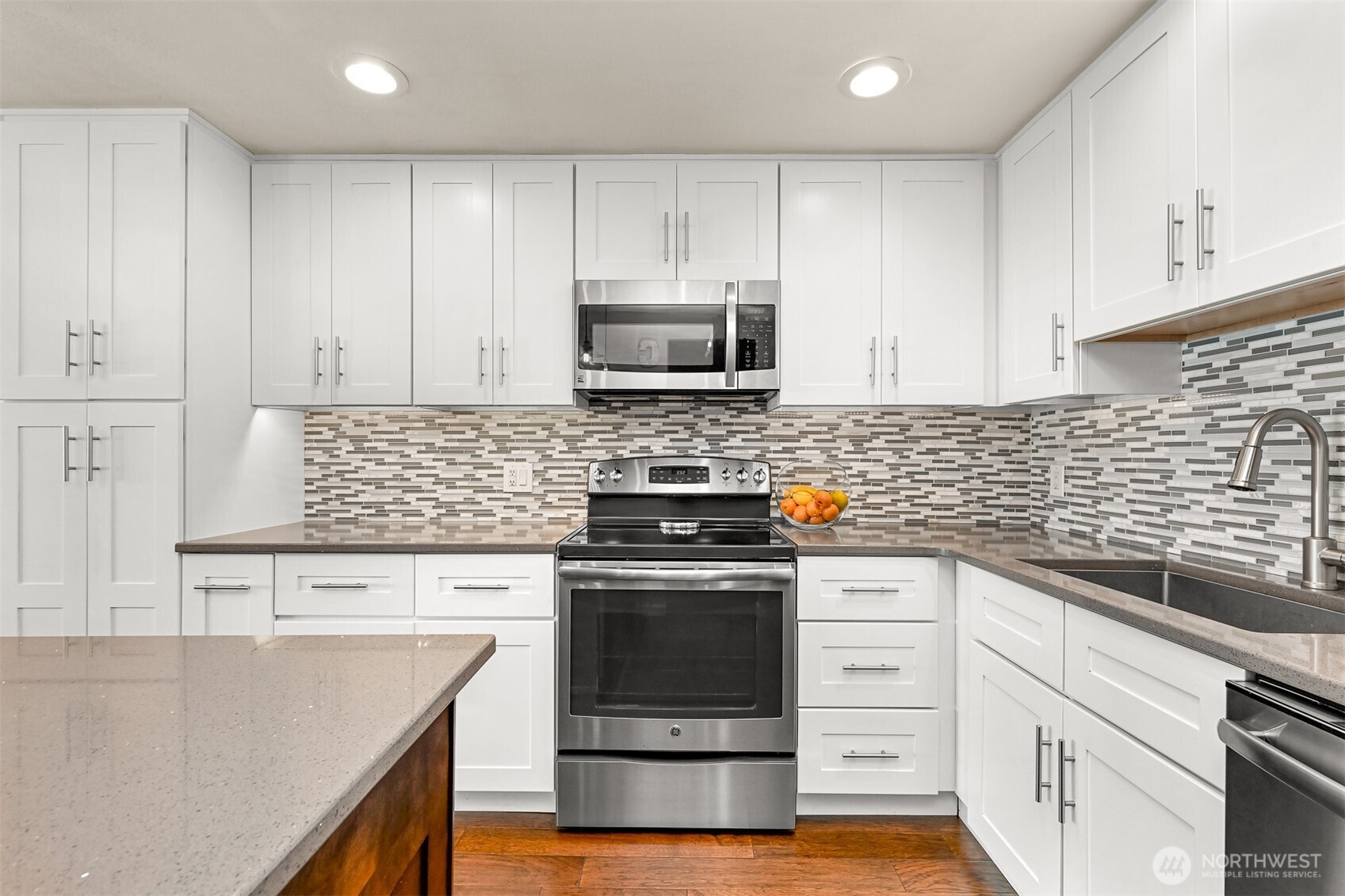 600 South State Street, Unit 212 Bellingham, WA 98225 - Photo 18 of 37 a kitchen with granite countertop white cabinets and stainless steel appliances