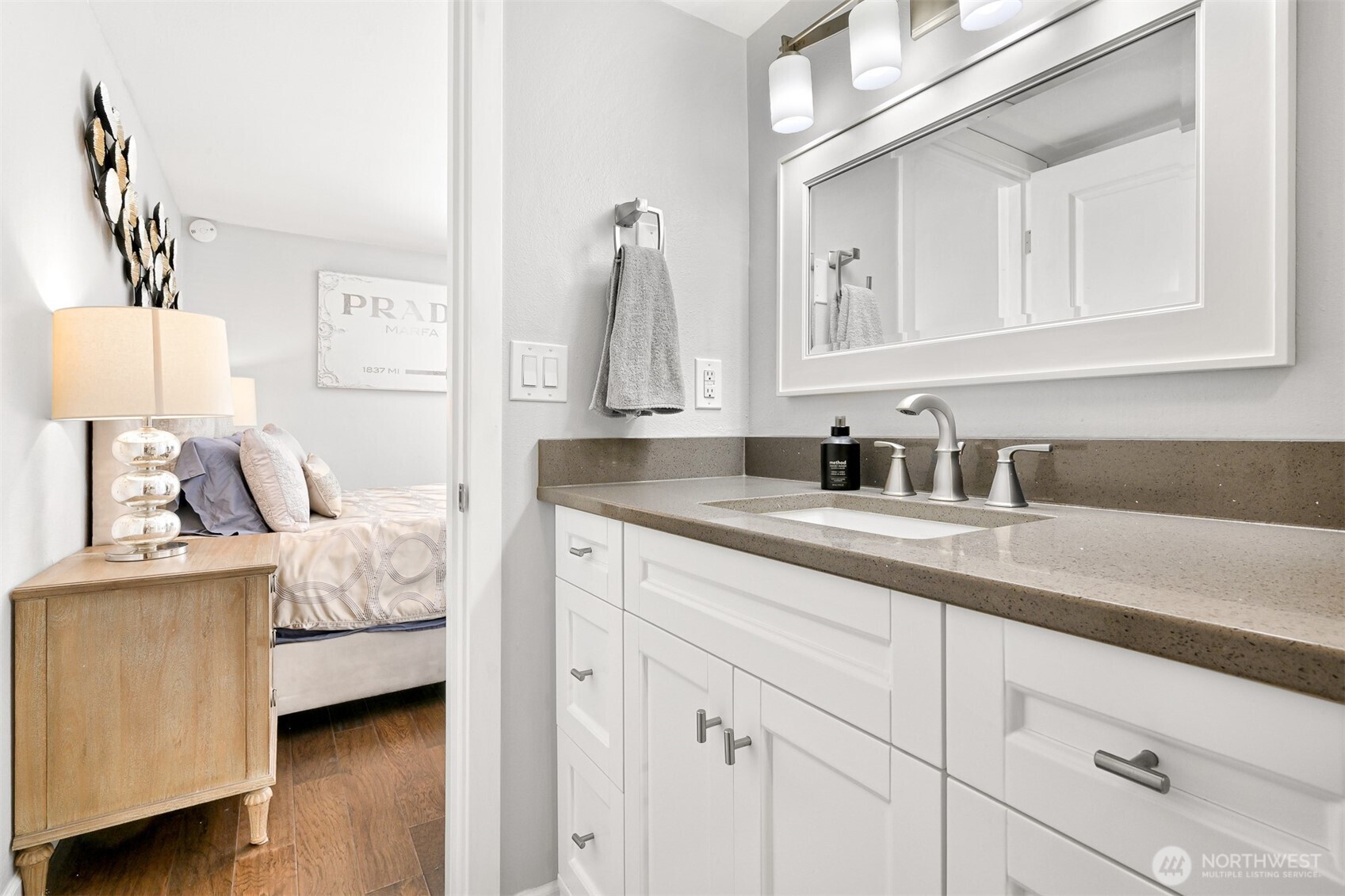 600 South State Street, Unit 212 Bellingham, WA 98225 - Photo 23 of 37 a en suite bathroom with a granite countertop sink and a mirror
