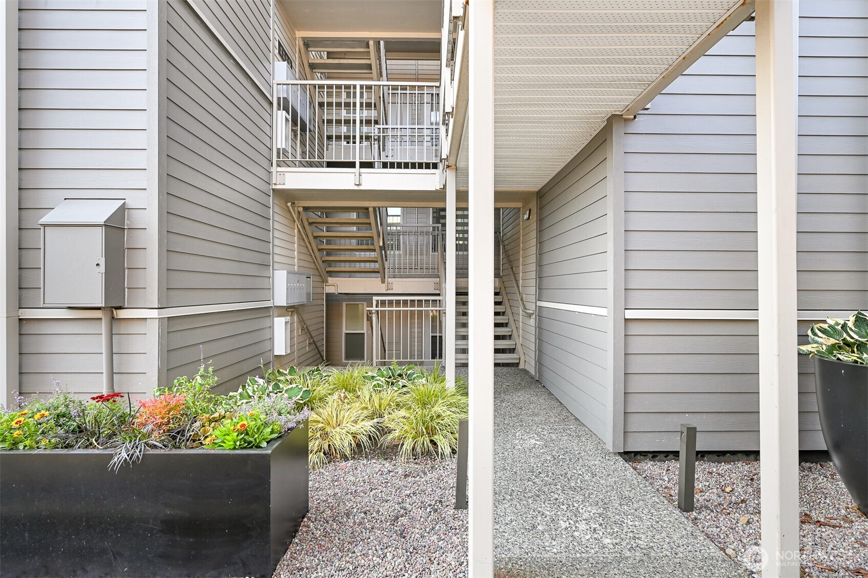 600 South State Street, Unit 212 Bellingham, WA 98225 - Photo 4 of 37 a view of a house with a potted plant
