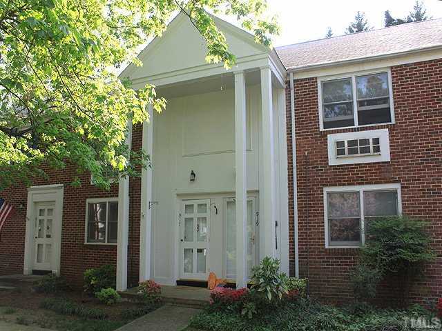 a front view of a house with plants