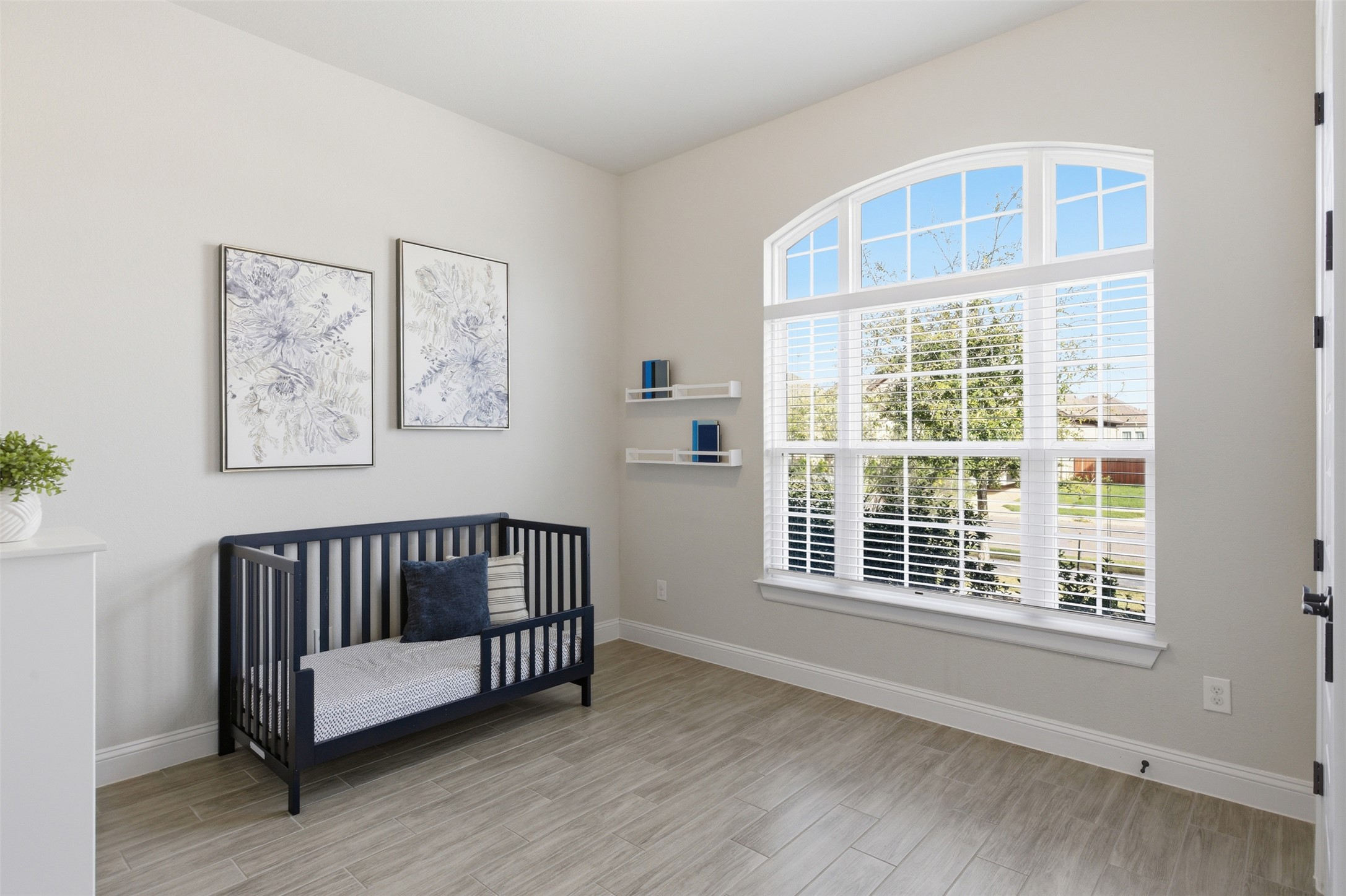117 Old Trinity Way Georgetown, TX 78628 - Photo 25 of 38 Bedroom featuring a nursery area and light wood finished floors