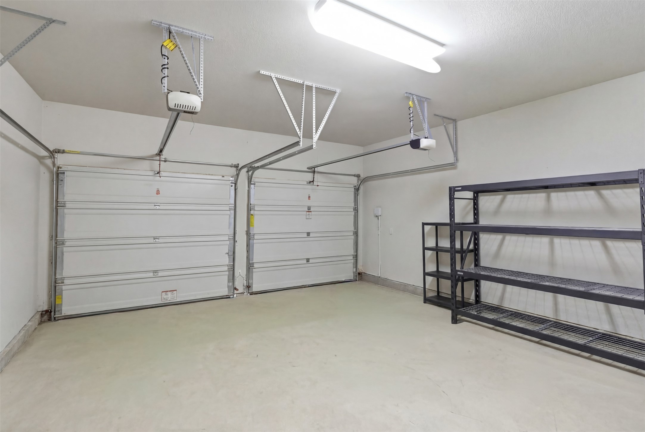 117 Old Trinity Way Georgetown, TX 78628 - Photo 30 of 38 Garage with baseboards and a garage door opener