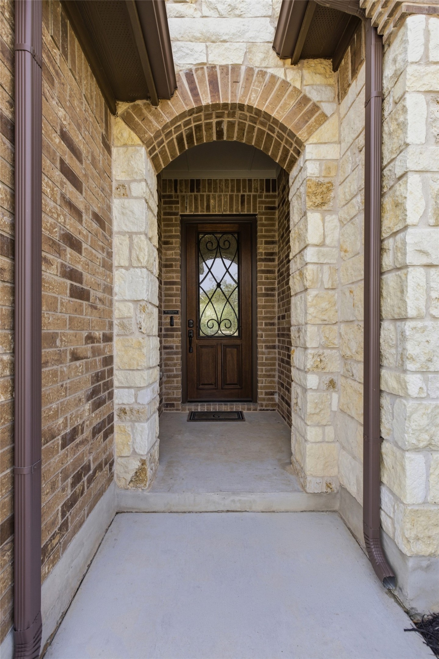 117 Old Trinity Way Georgetown, TX 78628 - Photo 7 of 38 Doorway to property featuring stone siding and brick siding