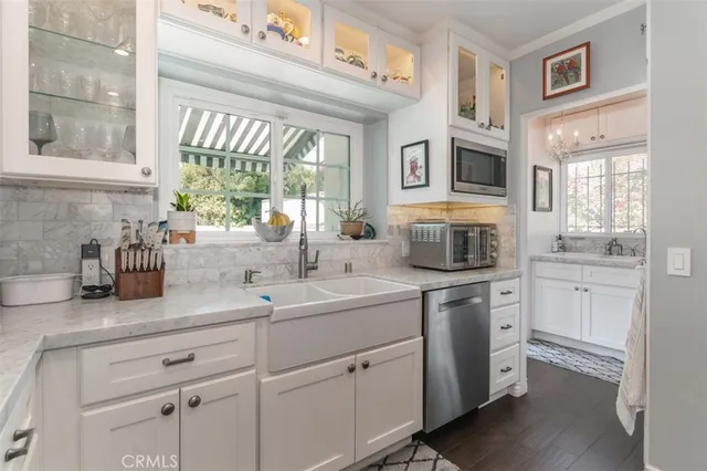 a kitchen with sink cabinets and window