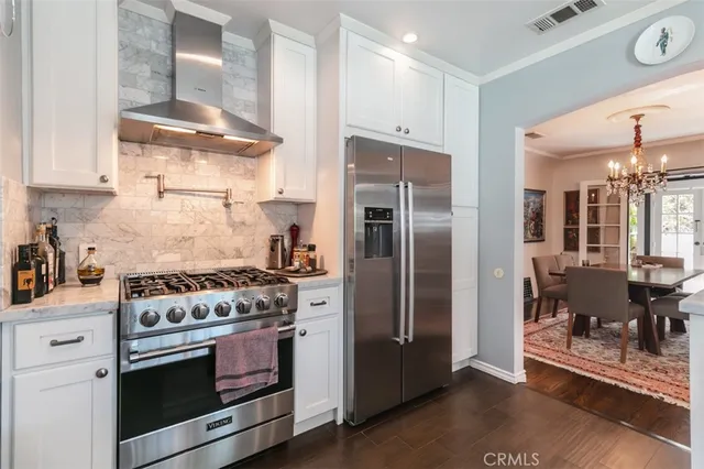 a kitchen with stainless steel appliances granite countertop a stove and a refrigerator