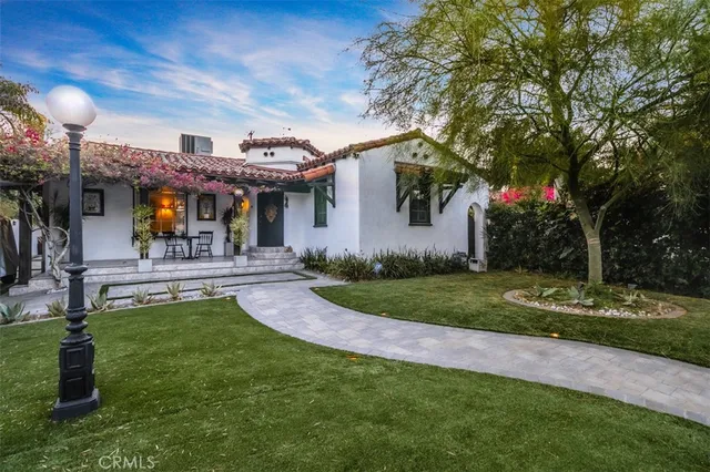 a front view of house with yard and outdoor seating