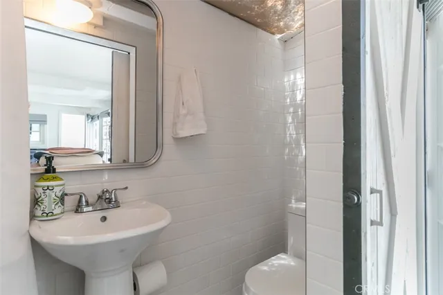 a bathroom with a sink toilet and mirror