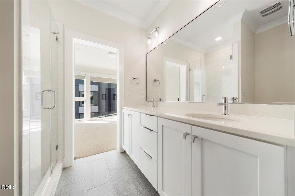 712 East Edenton Street, Unit 102 Raleigh, NC 27601 - Photo 9 of 17 a bathroom with a double vanity sink and mirror