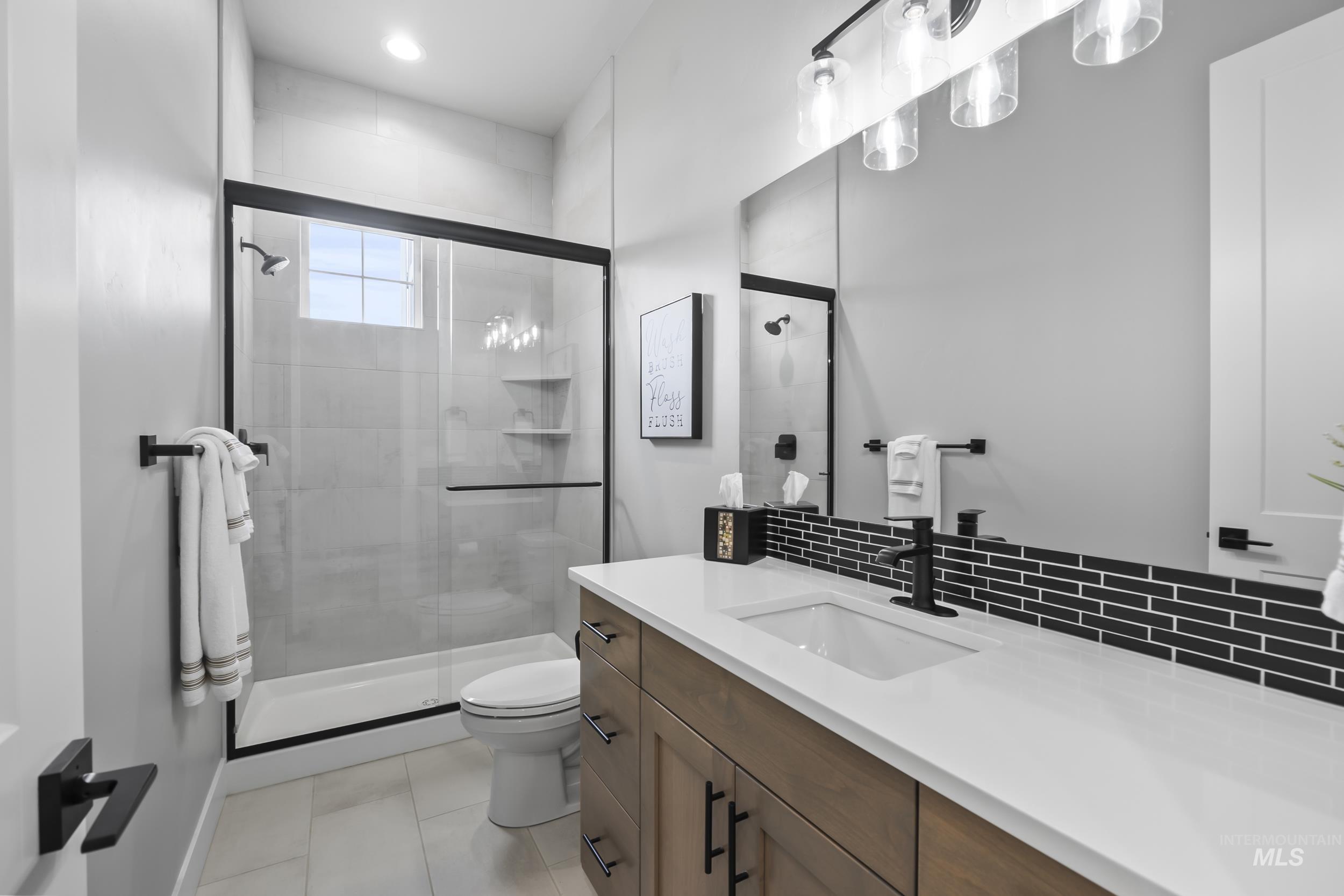 24696 Regal Road Middleton, ID 83644 - Photo 15 of 24 Bathroom featuring vanity, a shower stall, backsplash, and recessed lighting