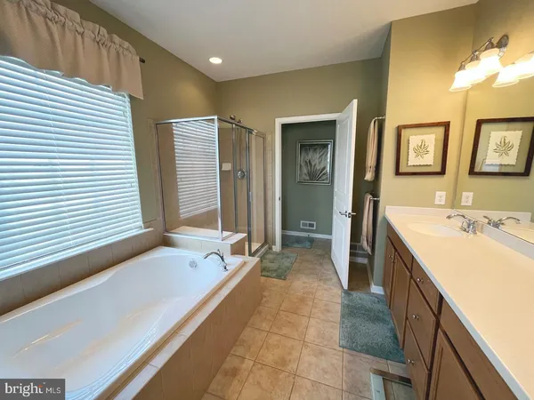 a spacious bathroom with a granite countertop sink and a large mirror