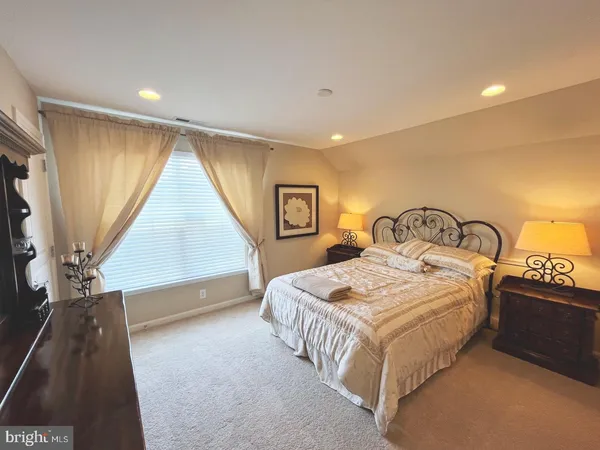 a bedroom with a bed and a night stand