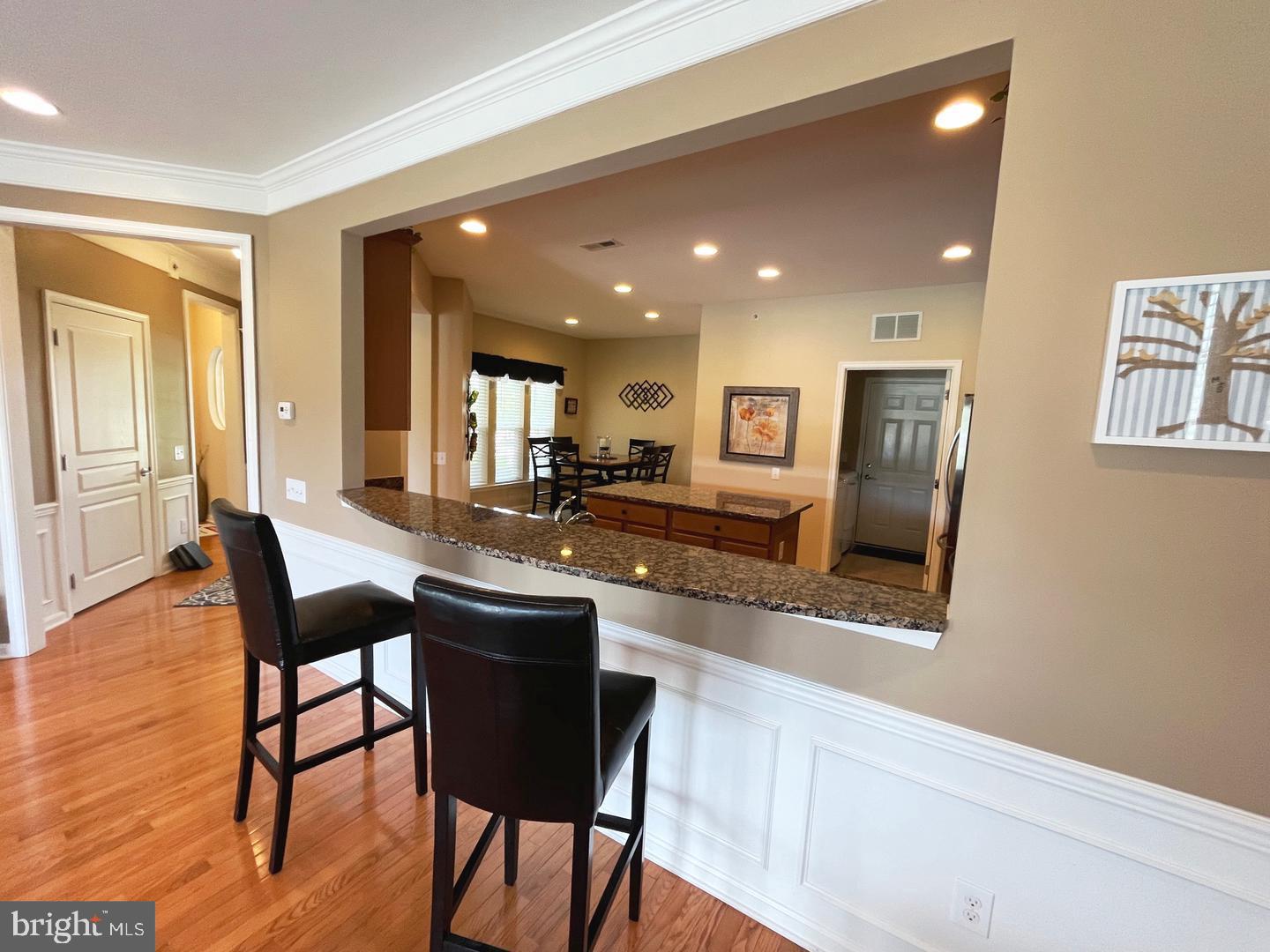 615 Prizer Court Downingtown, PA 19335 - Photo 5 of 35 a kitchen with stainless steel appliances granite countertop a table chairs sink and wooden floor