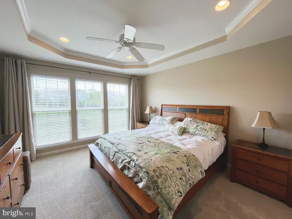 a large bedroom with a bed and large window