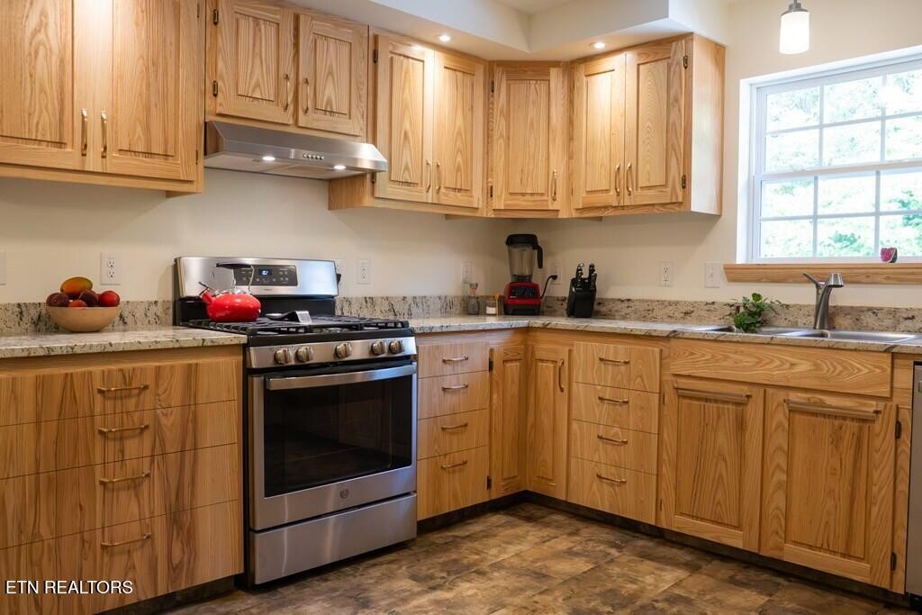 1518 Cummingsville And Sparkman Road Doyle, TN 38559 - Photo 25 of 58 a kitchen with stainless steel appliances granite countertop a stove a sink and dishwasher with white cabinets