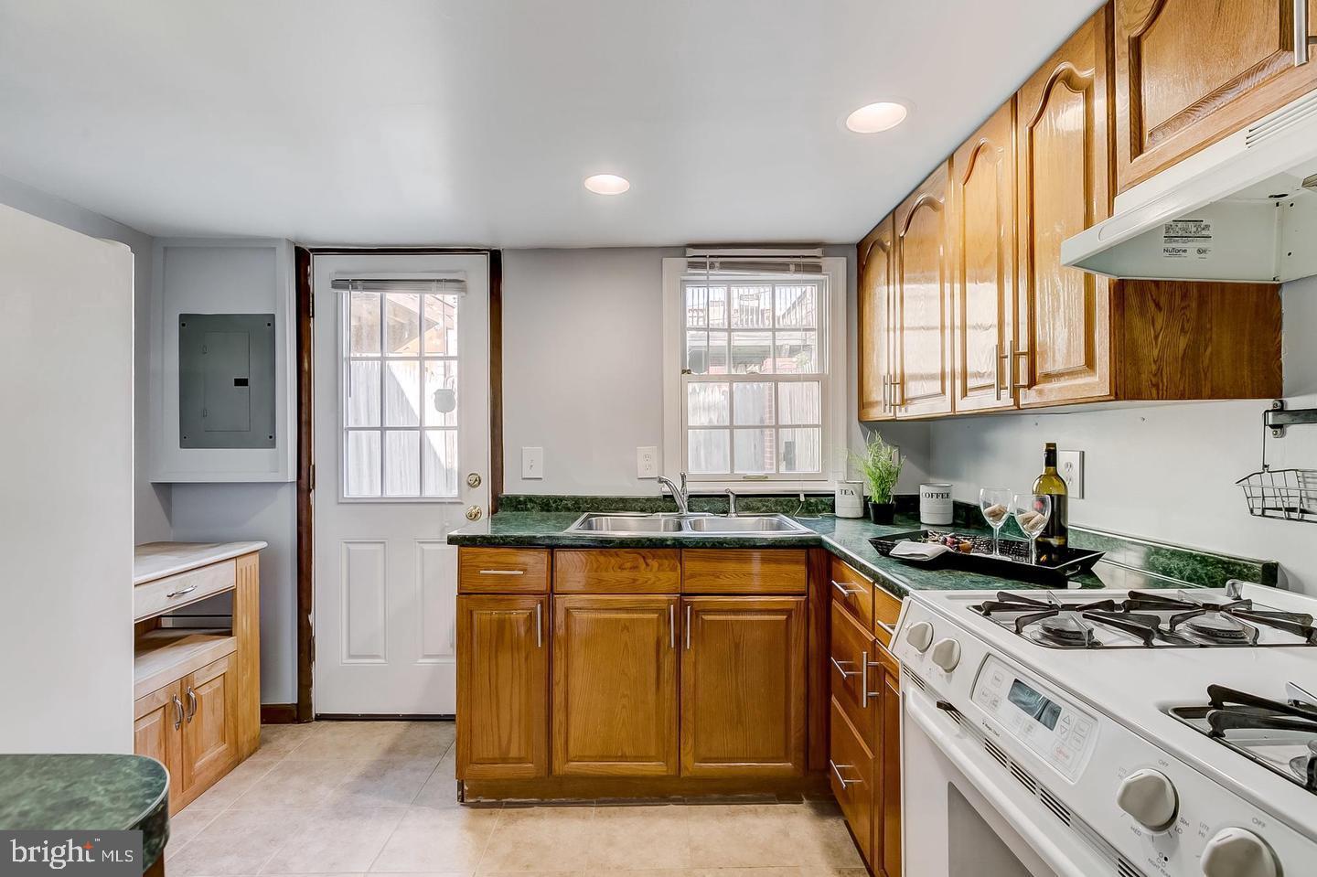 232 East Barney Street Baltimore, MD 21230 - Photo 11 of 23 a kitchen with stainless steel appliances granite countertop a stove a sink and a refrigerator