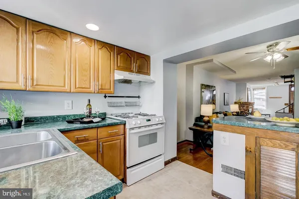 a kitchen with a stove a sink and a refrigerator