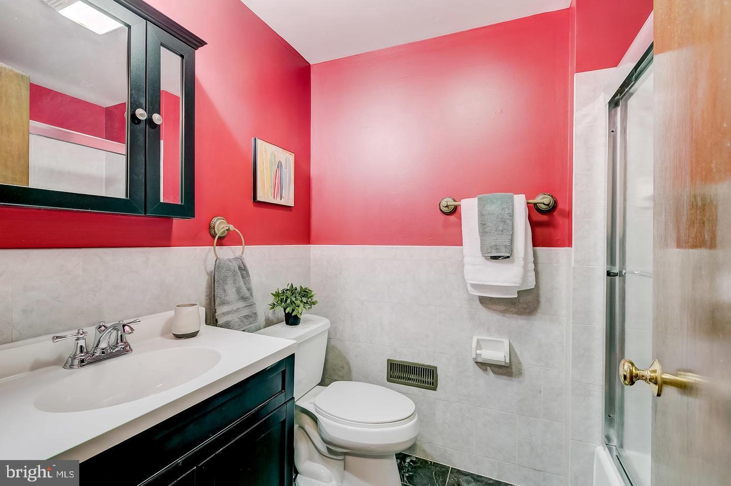 232 East Barney Street Baltimore, MD 21230 - Photo 21 of 23 a bathroom with a sink vanity mirror and toilet