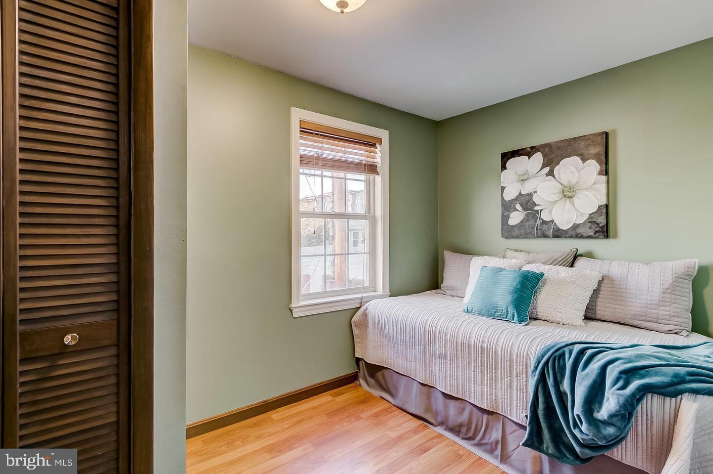 232 East Barney Street Baltimore, MD 21230 - Photo 23 of 23 a bedroom with a bed and a painting on the wall