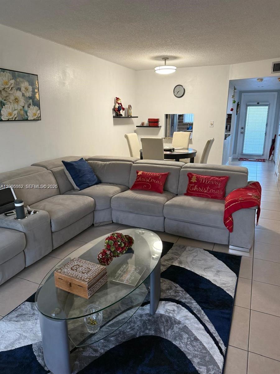2900 North Pine Island Road, Unit 209 Sunrise, FL 33322 - Photo 2 of 14 a living room with furniture and a large window