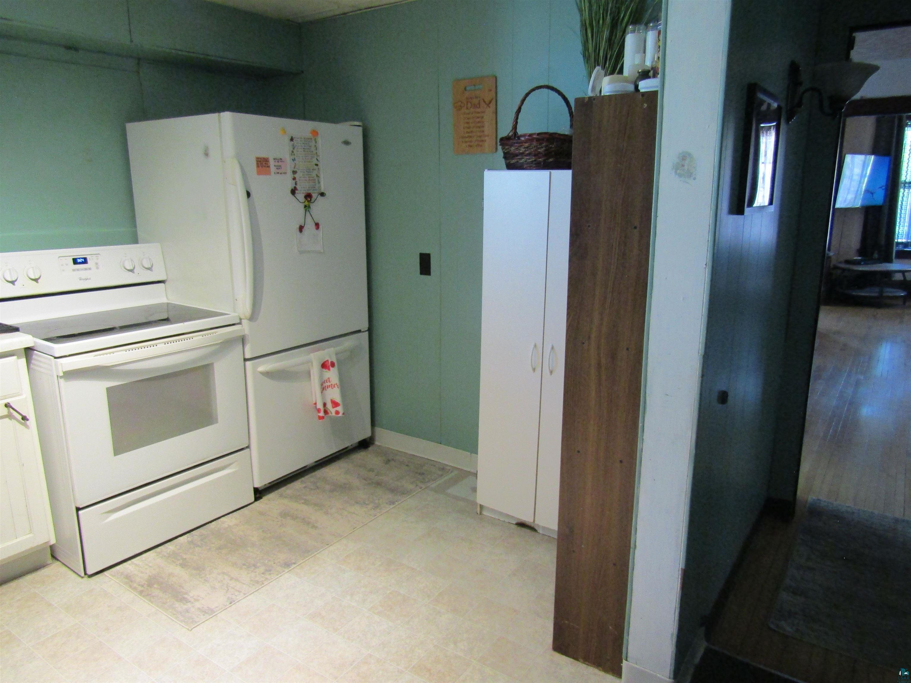 1115 Harrison Street Superior, WI 54880 - Photo 21 of 49 Kitchen featuring a white electric range, white refrigerator, and white cabinetry
