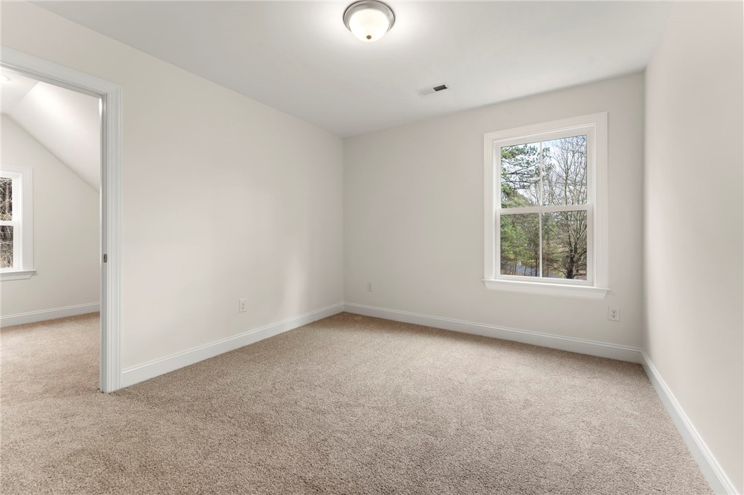 505 Fire Tower Road Williamston, SC 29697 - Photo 30 of 37 This bright bedroom offers ample natural light and a neutral palette, ideal for personalization.