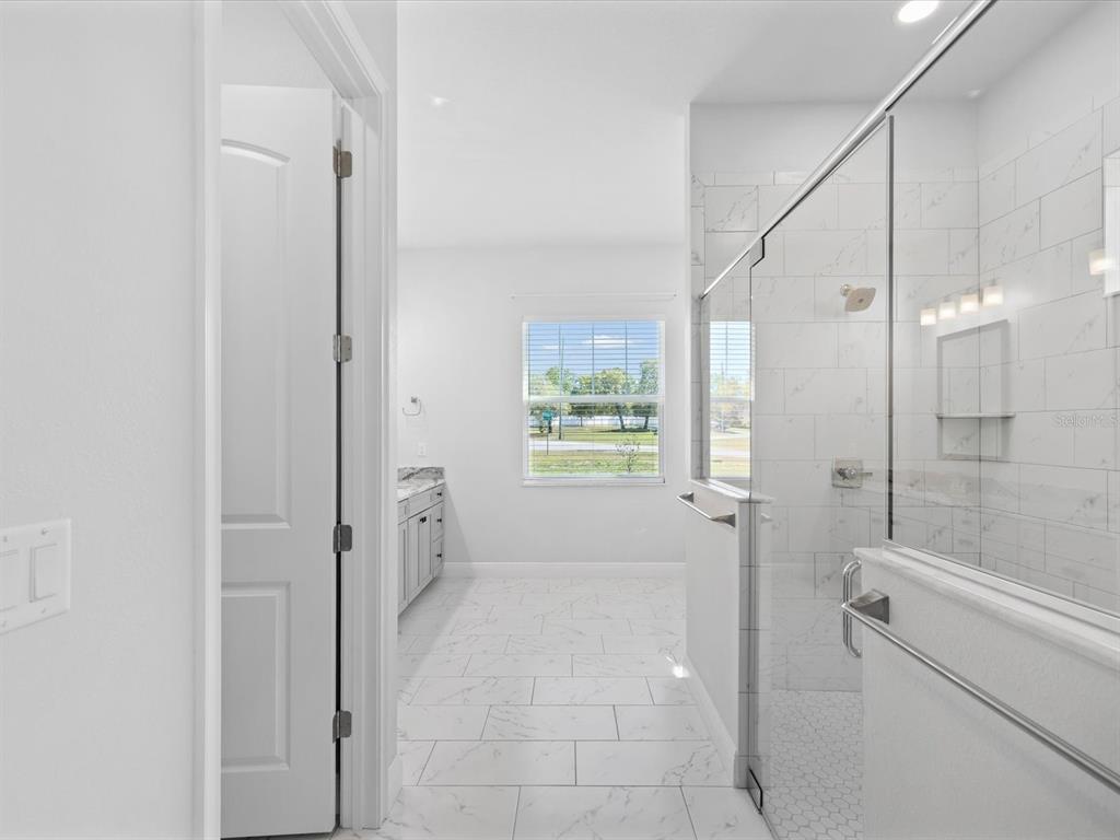 11981 Robina Road Weeki Wachee, FL 34614 - Photo 23 of 93 a bathroom with a shower and a tub