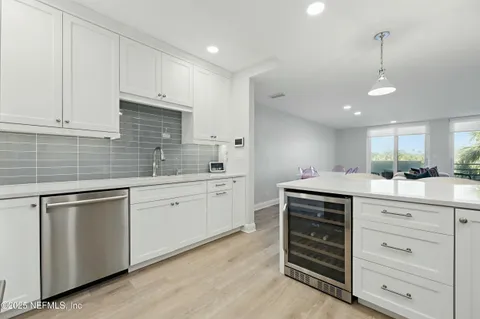 a kitchen with cabinets appliances and a sink