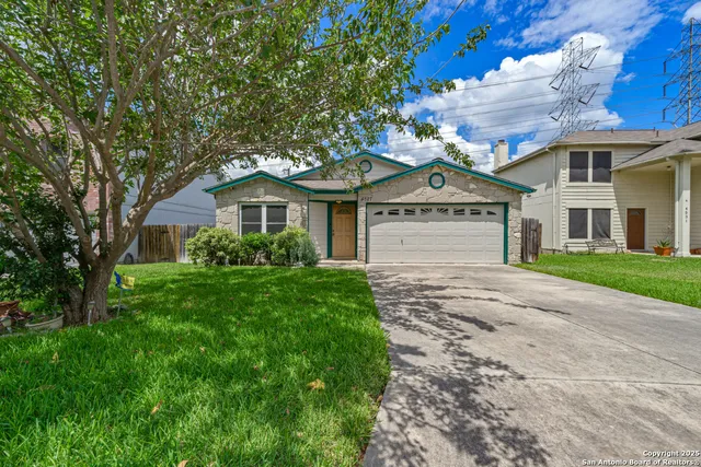a front view of a house with a garden and yard