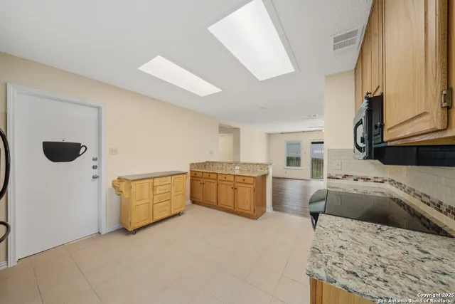 a kitchen with a stove a sink and a refrigerator