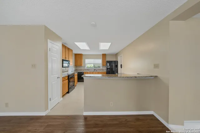 a view of a kitchen with wooden floor