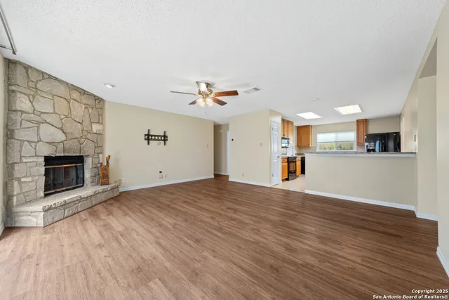 a view of a kitchen with a sink and a fireplace