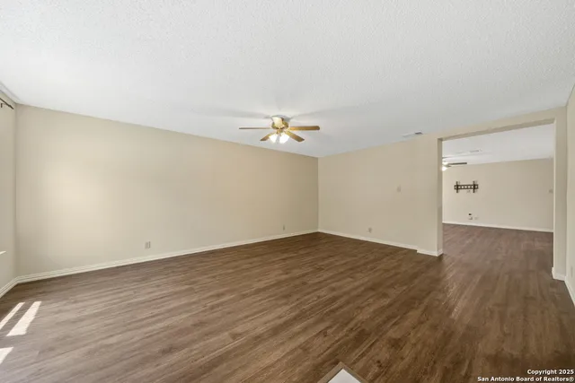 a view of empty room with wooden floor