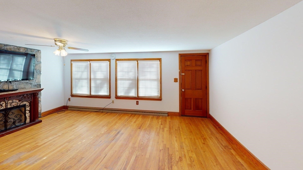 32 Morrison Court Methuen, MA 01844 - Photo 3 of 18 an empty room with wooden floor and a window
