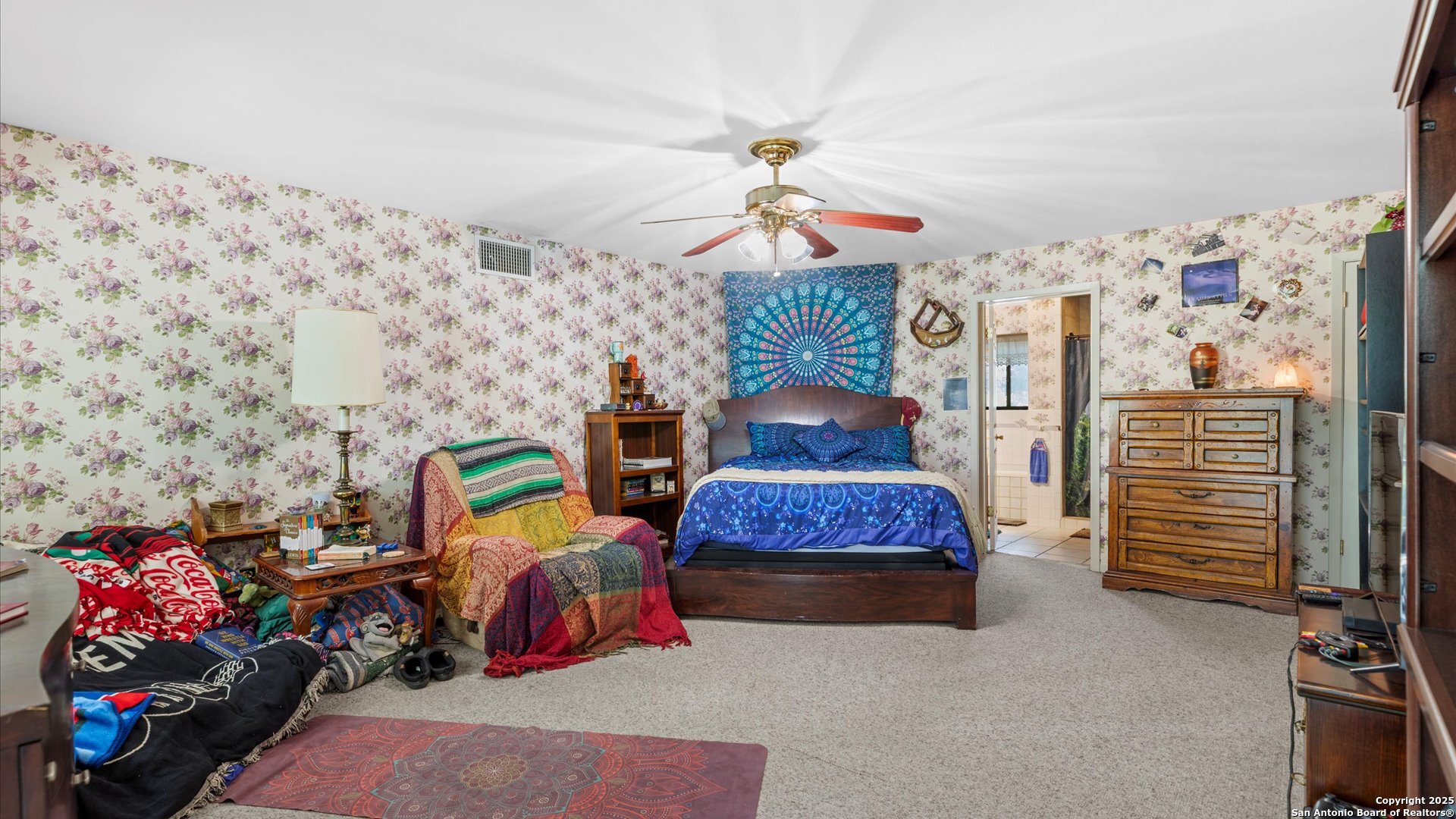 949 Burges Street Seguin, TX 78155 - Photo 13 of 26 a bedroom with furniture and a chandelier