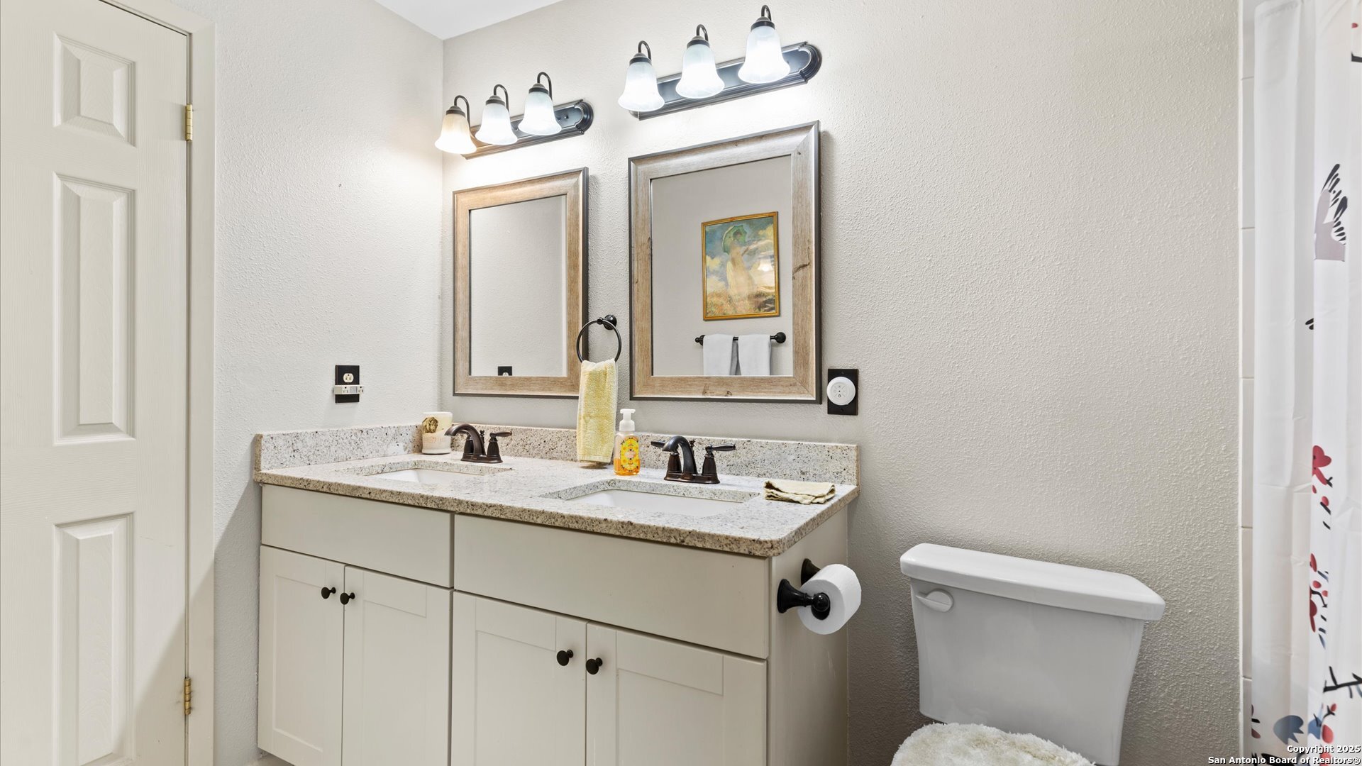 949 Burges Street Seguin, TX 78155 - Photo 18 of 26 a bathroom with a toilet sink and mirror