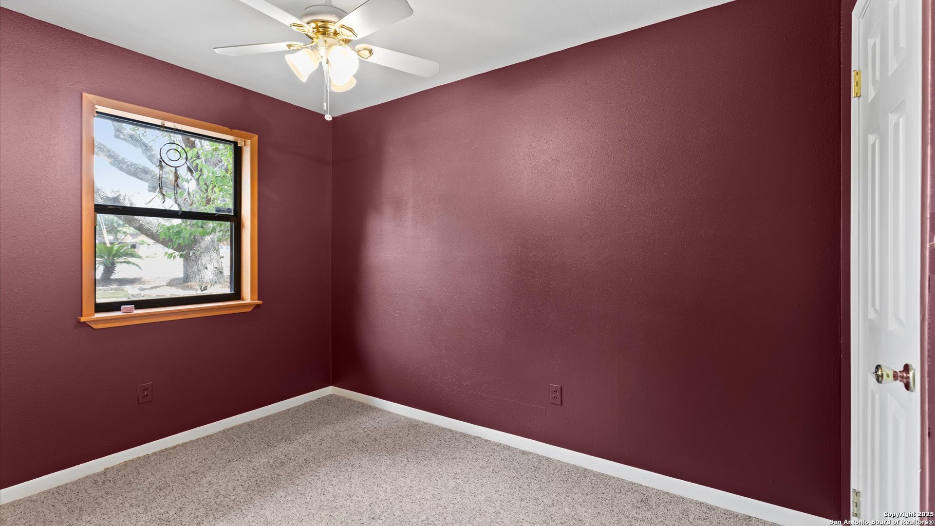 949 Burges Street Seguin, TX 78155 - Photo 20 of 26 an empty room with windows and chandelier fan