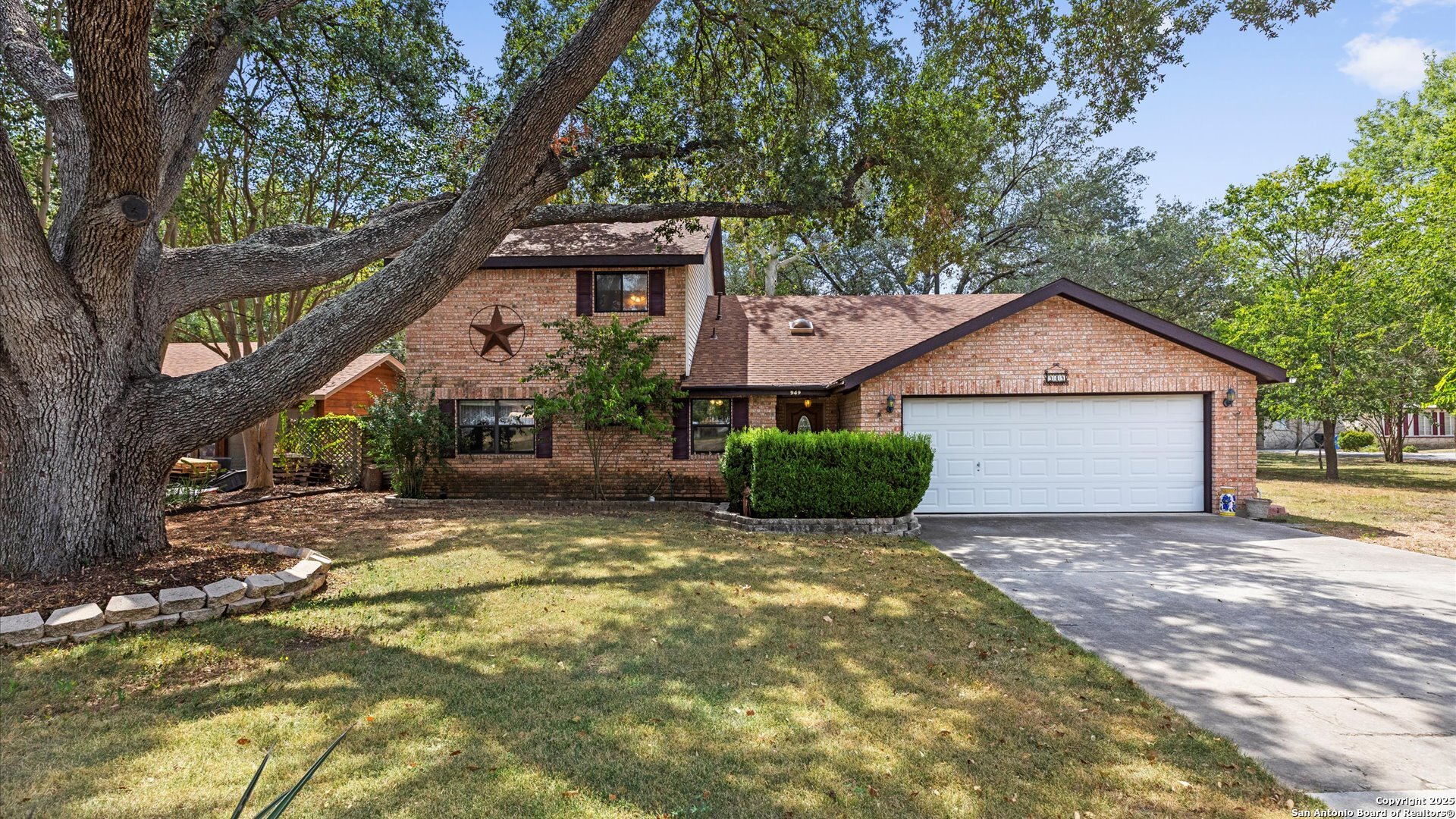 949 Burges Street Seguin, TX 78155 - Photo 2 of 26 a view of a house with a yard and large tree