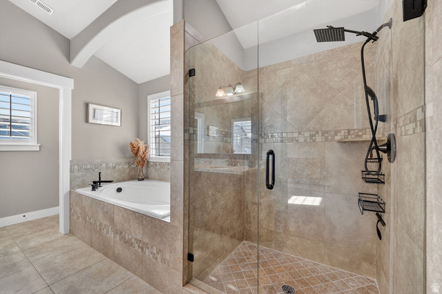 14714 South Bright Wood Road Herriman, UT 84096 - Photo 21 of 41 Primary en-suite Bathroom featuring a walk-in spa shower, deep bath, travertine tile floors, and lofted ceiling