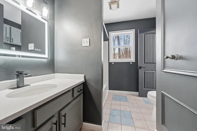 a bathroom with a sink a vanity and a mirror
