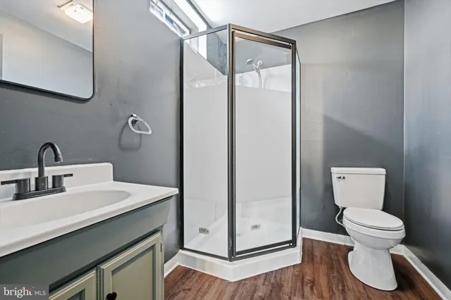 a bathroom with a toilet sink and shower