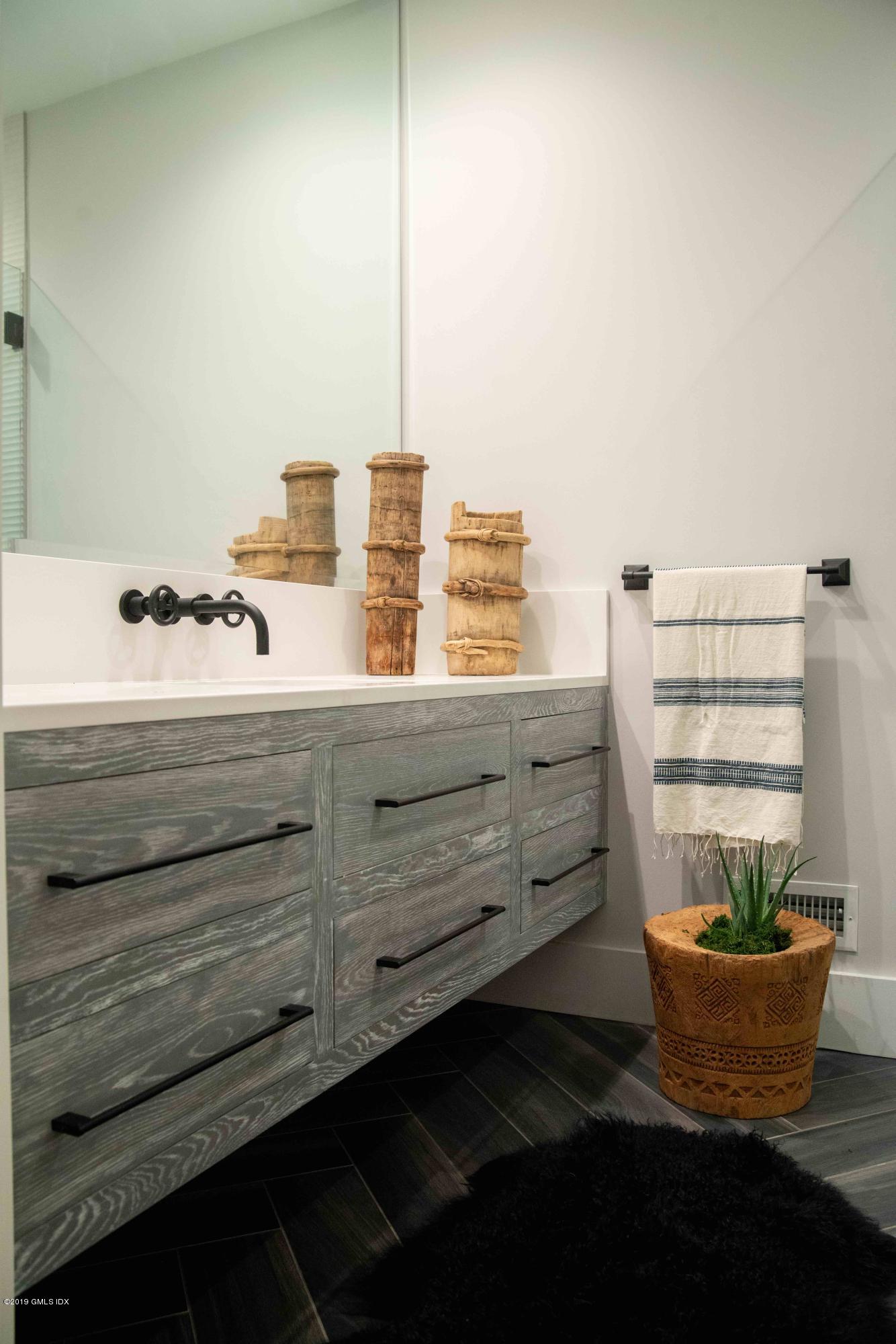 38 St Roch Avenue, Unit B Greenwich, CT 06830 - Photo 25 of 38 a room with a cabinet and mirror