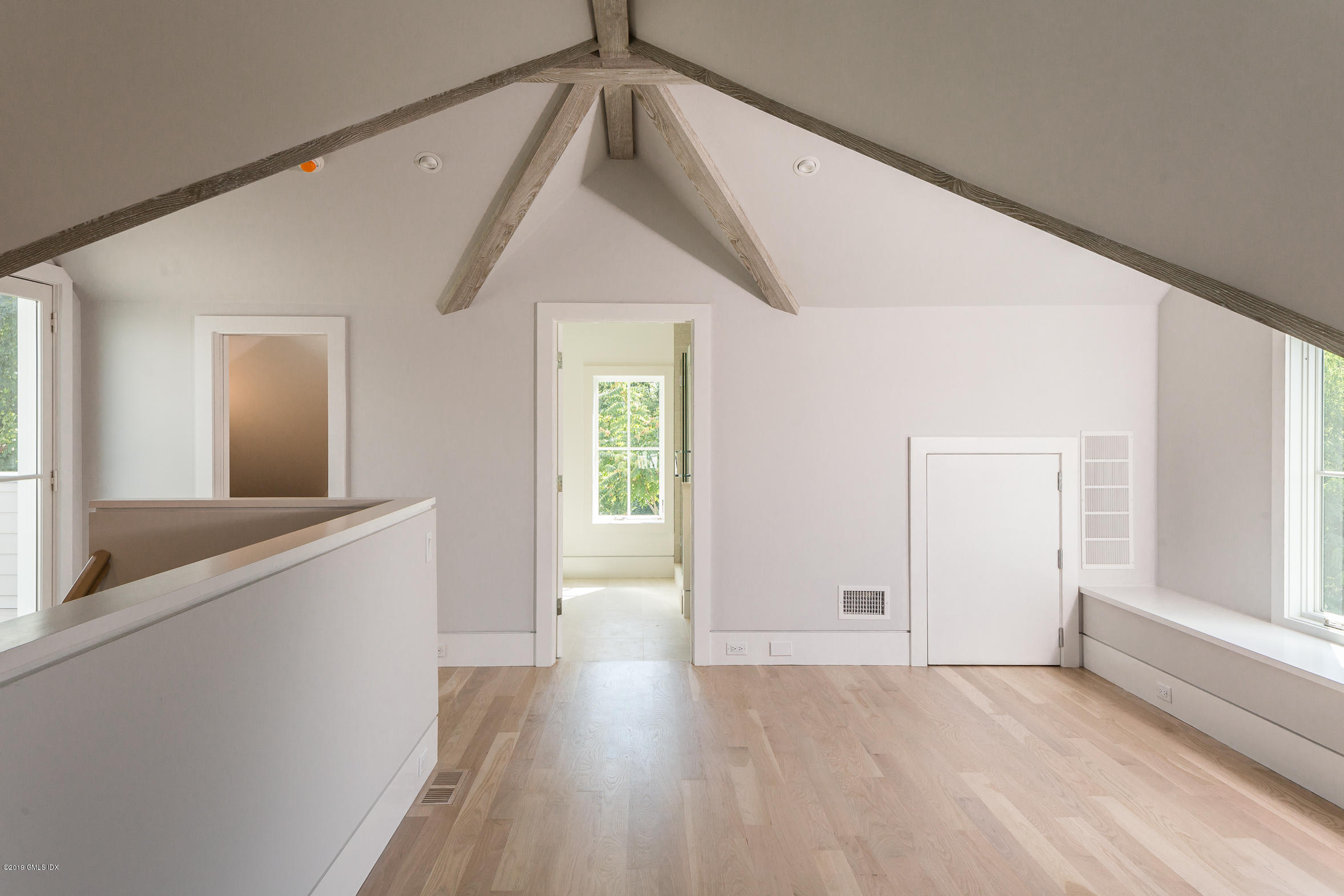 38 St Roch Avenue, Unit B Greenwich, CT 06830 - Photo 30 of 38 a view of a hallway with wooden floor and staircase