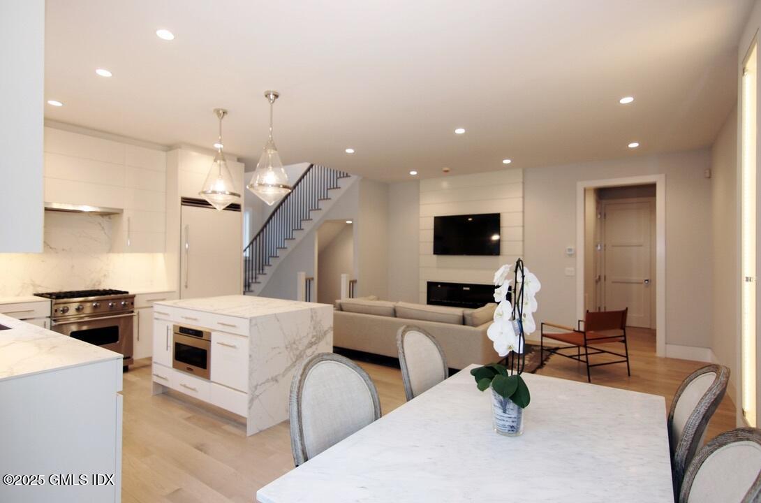 38 St Roch Avenue, Unit B Greenwich, CT 06830 - Photo 4 of 38 a living room with furniture and a flat screen tv