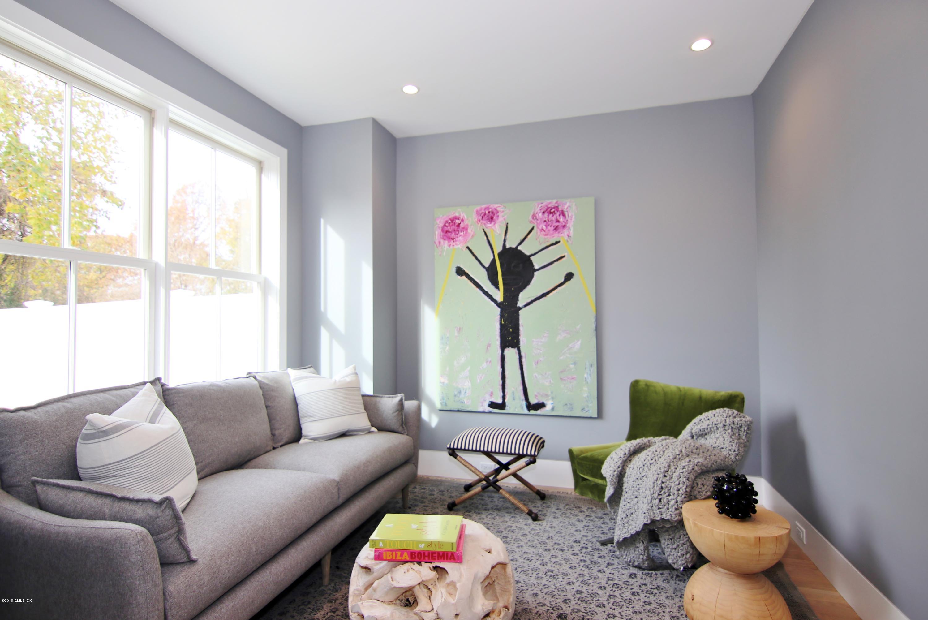 38 St Roch Avenue, Unit B Greenwich, CT 06830 - Photo 9 of 38 a living room with furniture and a large window